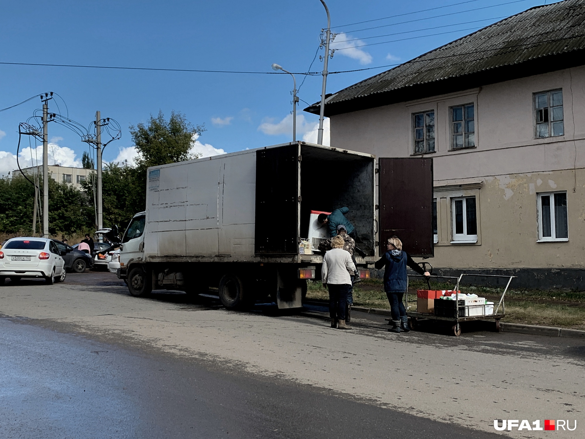 Женщина, продающая торты, загружает остатки в грузовик