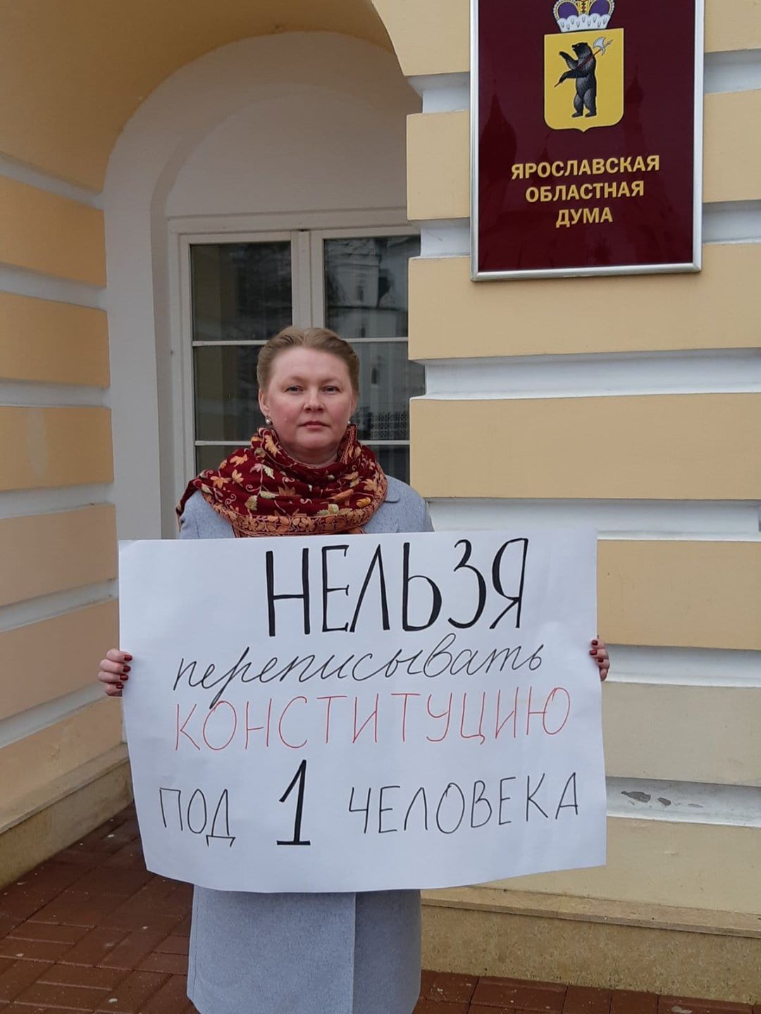Активистка от коммунистов перед заседанием думы развернула плакат Активистка от коммунистов перед заседанием думы развернула плакат