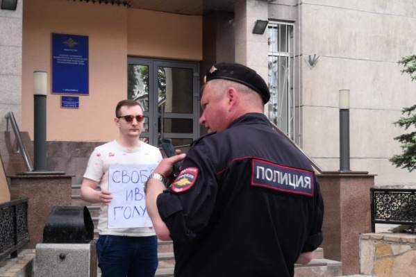 Алексей Чепрасов с плакатом около здания краевого управления МВД Алексей Чепрасов с плакатом около здания краевого управления МВД