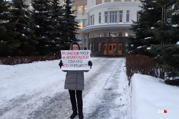 Одна из активисток встала с плакатом около входа в областное правительство Одна из активисток встала с плакатом около входа в областное правительство