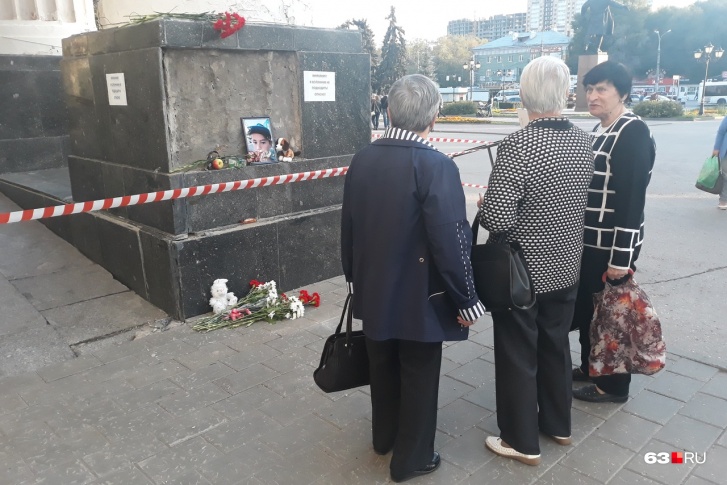 Прохожие останавливаются, чтобы почтить память мальчика Прохожие останавливаются, чтобы почтить память мальчика